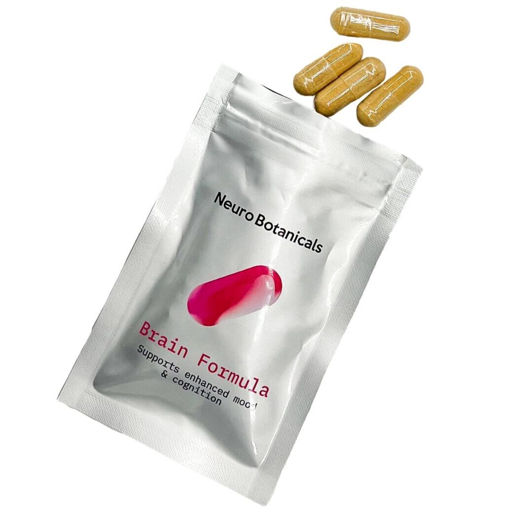 Close up of uniform clear vegetable capsules filled with a finely ground Brain Formula blend botanical powder